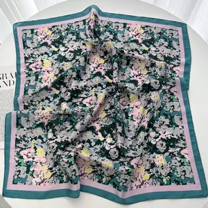 Detailed view of colorful floral silk square scarf with contrasting double-tone borders