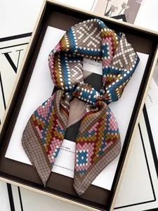 Detail of elegant silk scarf with pixelated geometric pattern in luxury gift box