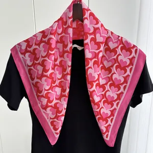 Elegant red heart pattern silk scarf for women displayed on a black shirt hanger