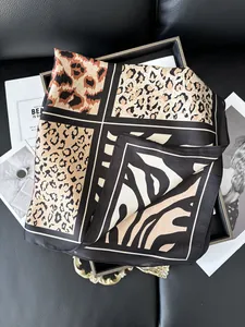 Detail of elegant satin scarf with animal prints including leopard and zebra patterns
