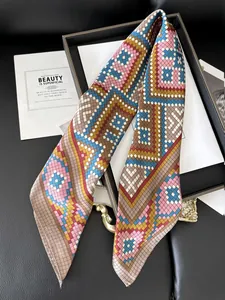 Detail of printed silk twill scarf with retro geometric patterns on black display tray