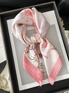 Detailed view of floral pattern silk scarf with pink and cream flower prints and edge stitching
