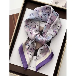 Elegant floral silk scarf in lavender and ice blue with a stylish ribbon bow shape