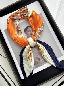 Detailed shot of pleated silk scarf with vintage baroque chain print and tricolor patterns