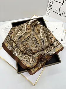 Detail of elegant paisley print silk scarf with satin finish and contrast border