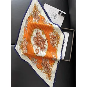 Pleated square silk scarf with orange horse carriage print on leather background