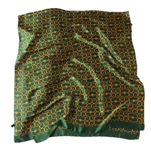 Elegant emerald green silk scarf with orange interlocking chain patterns on white background