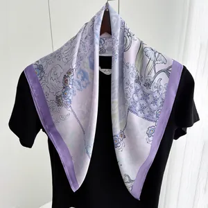 Close-up of floral print silk scarf with deep purple borders and polka dot details