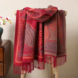 Close-up of thick winter shawl with retro wave patterns and elegant fringe details