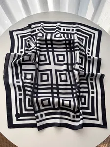 Dettaglio del foulard quadrato in seta con motivi geometrici bianchi e neri