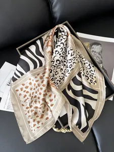 Detailed view of satin leopard and zebra print square scarf with premium silky texture