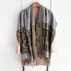 Detailed view of ethnic paisley pattern and fringe on heavy winter shawl wrap