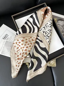 Detailed view of silky leopard and zebra print scarf with premium satin finish