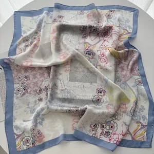 Detail of artistic floral pattern on 70cm satin square scarf with light blue border
