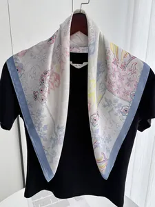 Detailed view of 70cm floral satin scarf draped over a black shirt with blue borders