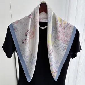 Detail of satin floral paisley silk scarf with pastel prints on elegant black garment