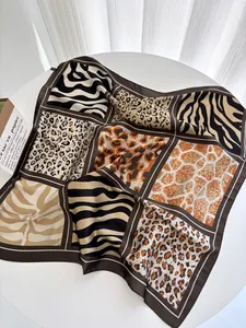 Detailed view of square silk scarf featuring collage of leopard and zebra animal prints