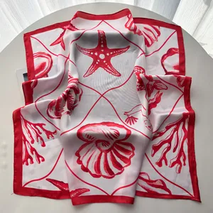 Detail of red starfish and seashell print on a lightweight white square silk scarf