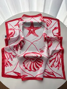 Detailed close-up showing the smooth silk texture and red starfish print on the scarf