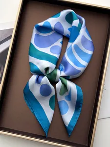 Close-up of geometric pattern silk scarf in a luxury gift box with smooth texture