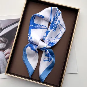 Close-up of ocean-themed starfish print silk scarf elegantly tied inside a gift box