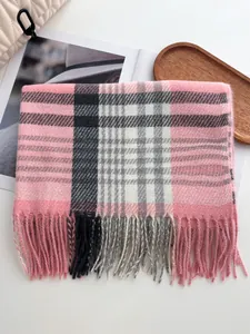 Gros plan d'une écharpe à carreaux rose et noir avec des franges douces et tissu