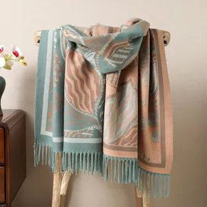 Detail of a thick double-sided shawl with abstract wave patterns and elegant fringe tassels
