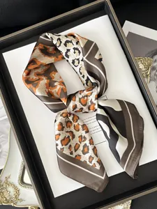 Close-up of luxury leopard and zebra print silk scarf on decorative display