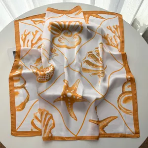 Detailed close-up showing the smooth satin texture and ocean starfish print on the silk scarf