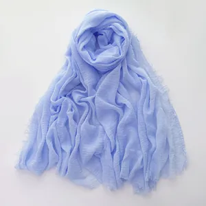 Light blue cotton linen scarf with textured wrinkles and frayed fringe edges for women