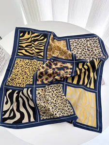 Detail of square silk scarf featuring a grid of mixed animal prints like leopard and zebra