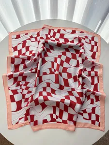 Detail of red and white checkered silk scarf with warped geometric patterns and peach edges