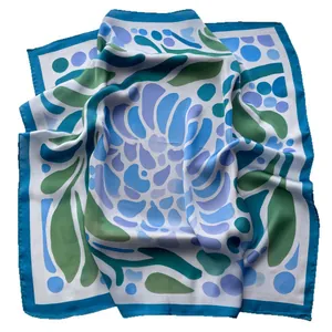 Square silk scarf with blue and green abstract floral patterns on white background