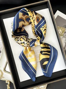 Detail of silk-feel scarf featuring a mix of leopard and tiger prints in a knot style
