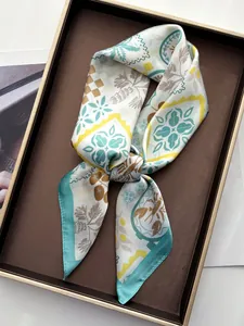 Detailed view of palm leaf printed silk scarf elegantly knotted on leather tray