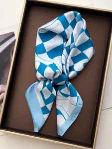 Detail of blue and white checkered silk scarf on a brown tray with gold metallic edges