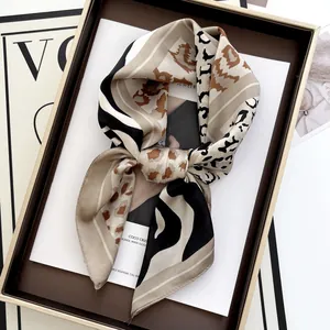 Elegant leopard print silk scarf with geometric stripes on luxury magazine background