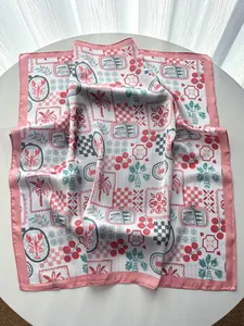 Detailed macro view of elegant silk scarf with palm tree and lobster print patterns