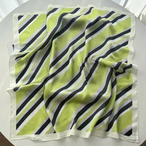 Close-up of green and purple striped silk square scarf with premium stitched edges