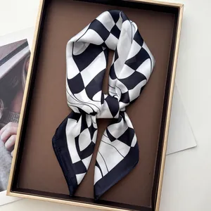 Close-up of black and white checkered silk scarf on a coffee tray with magazine decor