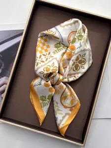 Detailed close-up of geometric coconut palm and citrus print silk scarf on display