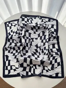 Macro shot of geometric black and white wavy checkered pattern on luxury square silk scarf