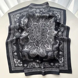 Detail of vintage black and white paisley floral silk scarf with soft silk texture
