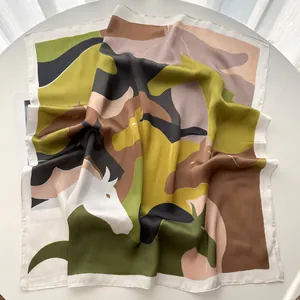 Detailed view of square silk scarf with horse head print and hand-rolled edges