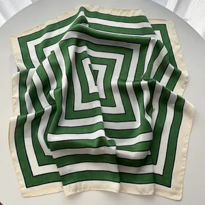Detailed view of striped green and white silk scarf with soft fabric texture and glossy finish