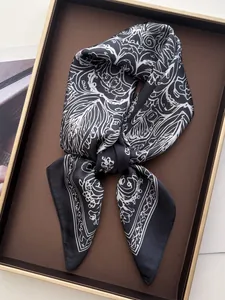 Detailed view of black and white floral silk scarf tied in a decorative knot