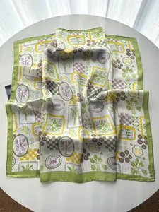 Detail view of silk square scarf featuring vintage lobster and palm tree prints on table