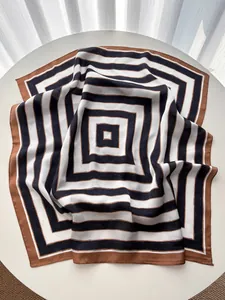 Detail of striped silk square scarf showing smooth texture and geometric pattern