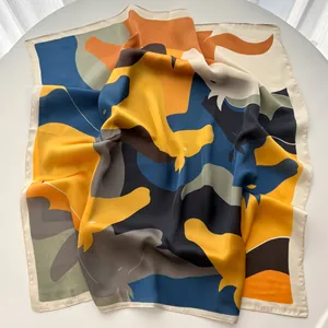 Detail shot of a silk square scarf with abstract geometric patterns and smooth texture