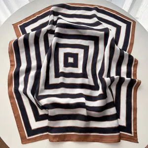 Close-up of a striped silk neckerchief with brown and navy blue geometric patterns